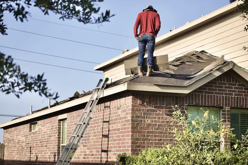 Professional roofer working on a residential roof in Foxburg